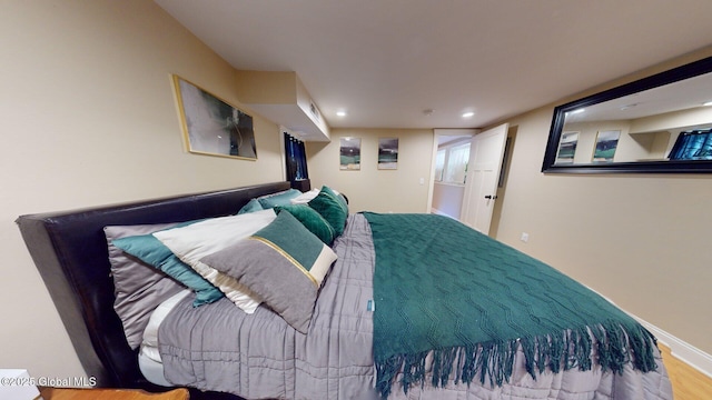 bedroom with baseboards and wood finished floors