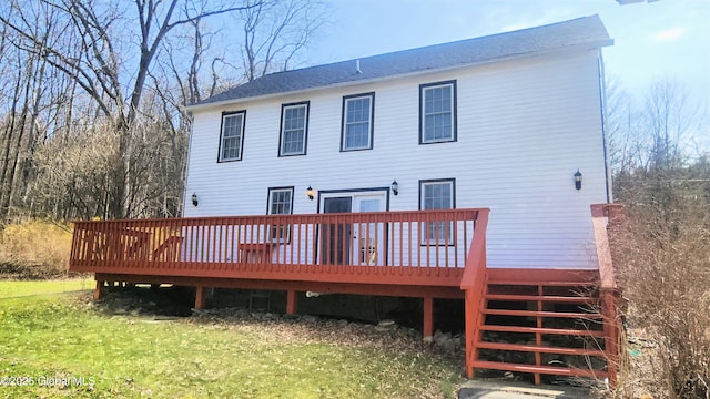 rear view of house with a yard and a wooden deck