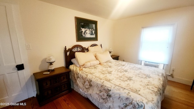 bedroom with dark wood-style floors
