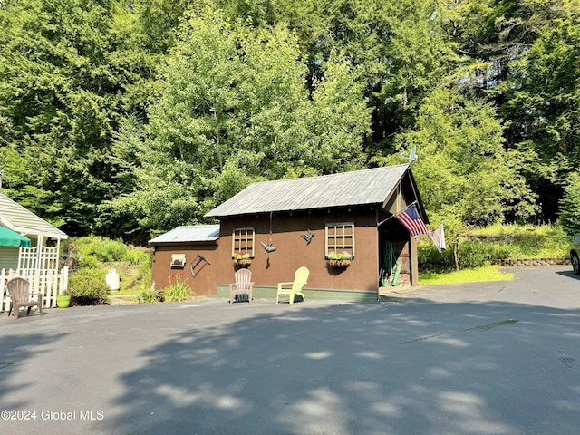16 Pumphouse Rd, Lake Luzerne, NY 12846 - exterior space with an outbuilding and a view of trees