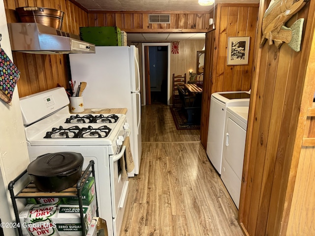 16 Pumphouse Rd, Lake Luzerne, NY 12846 - kitchen featuring light wood-style flooring, white range with gas stovetop, wood walls, visible vents, and ventilation hood