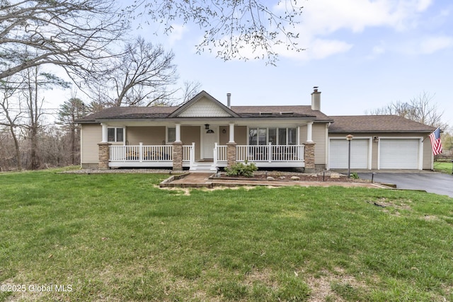 view of front of house with a chimney, a front lawn, driveway, a porch, and a garage