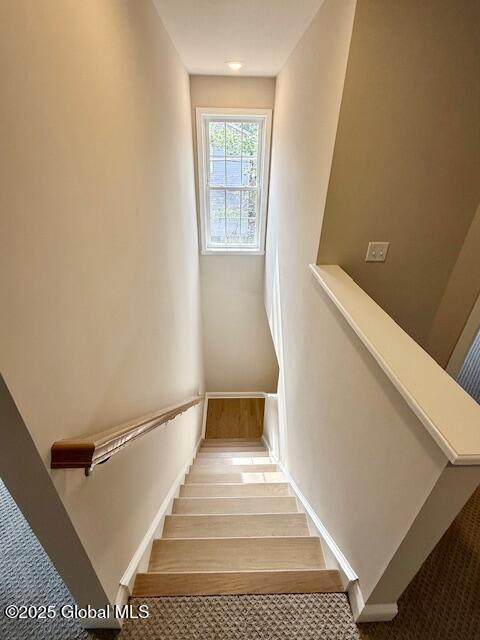 stairway with carpet floors and baseboards