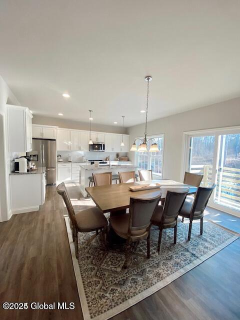 dining space with dark wood-style flooring and recessed lighting