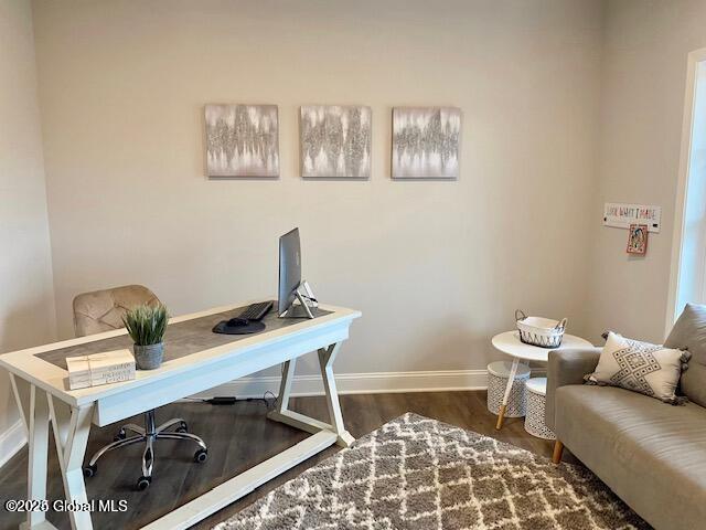 office with dark wood-type flooring and baseboards