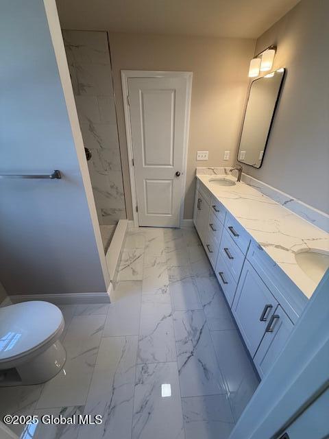 full bathroom with baseboards, a sink, toilet, double vanity, and marble finish floor