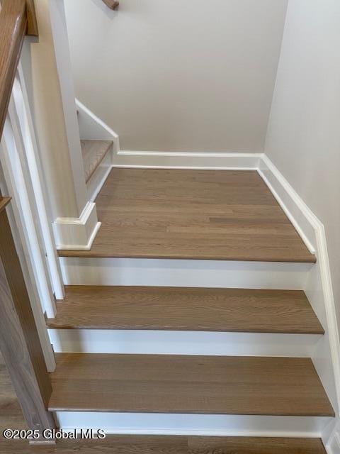 staircase featuring baseboards