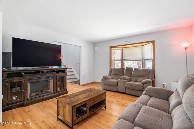 living room featuring baseboards and light wood-style flooring