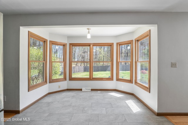 interior space with baseboards and visible vents