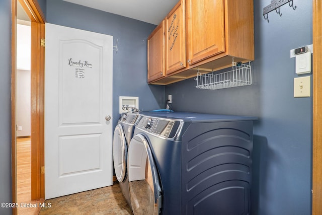 washroom featuring cabinet space and independent washer and dryer