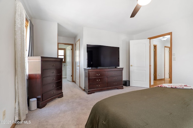 bedroom with a ceiling fan and light colored carpet