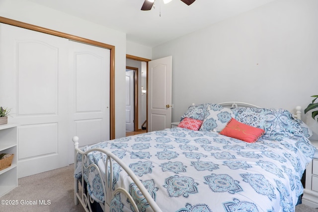 carpeted bedroom with ceiling fan and a closet