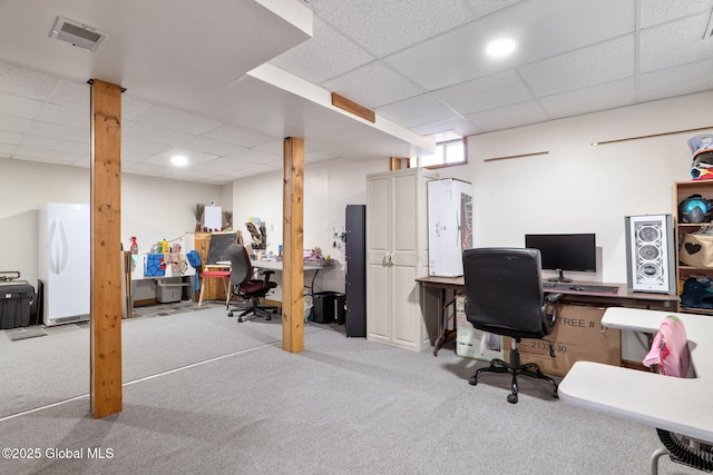 carpeted office space with a drop ceiling and visible vents