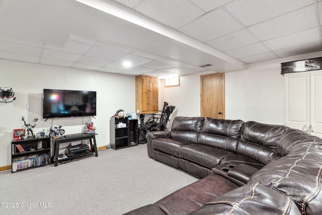 carpeted living area featuring visible vents, baseboards, and a drop ceiling
