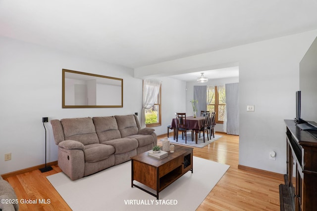 living room featuring light wood-type flooring and baseboards