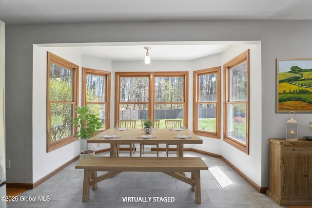 dining area with baseboards and light tile patterned floors