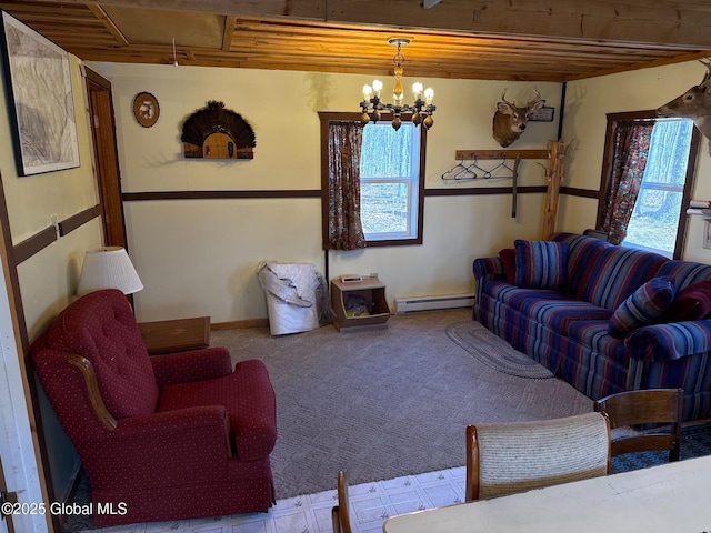 carpeted living room with a chandelier, a wealth of natural light, baseboard heating, and wooden ceiling