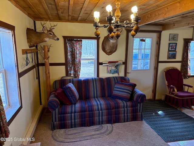 carpeted living room featuring wooden ceiling, baseboards, a chandelier, and a baseboard radiator