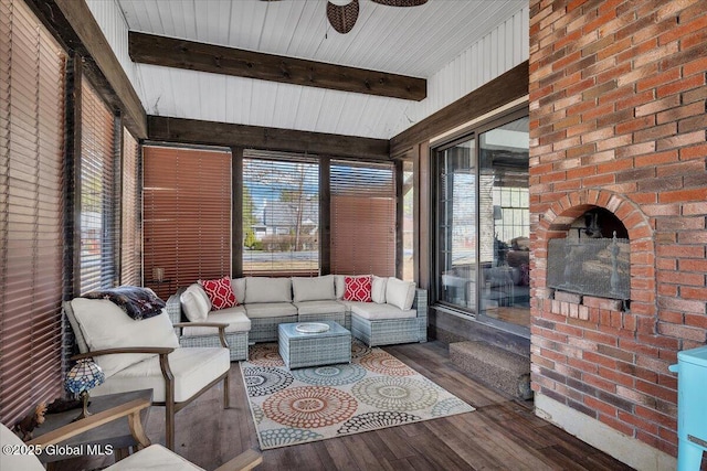 sunroom featuring a wealth of natural light, wood finished floors, and beam ceiling