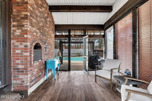 sunroom / solarium featuring beam ceiling