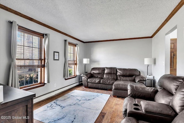 living area with a baseboard heating unit, crown molding, wood finished floors, and a textured ceiling