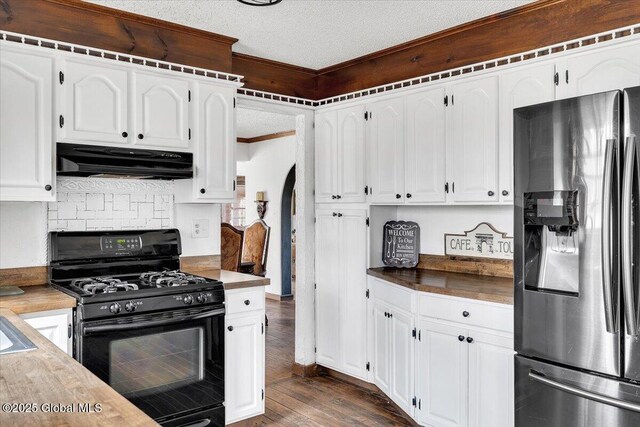 kitchen featuring black gas stove, a textured ceiling, dark wood finished floors, stainless steel refrigerator with ice dispenser, and under cabinet range hood