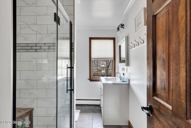 bathroom featuring a stall shower, baseboards, baseboard heating, vanity, and ornamental molding