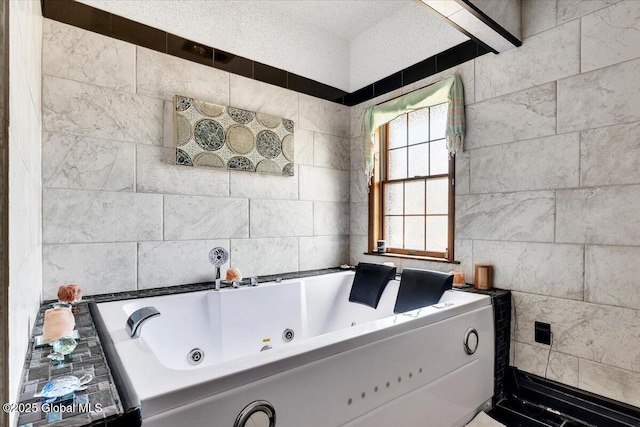 full bath featuring a whirlpool tub and tile walls