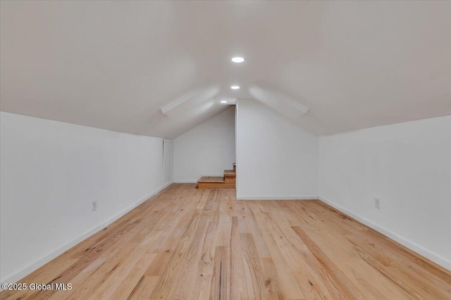 bonus room featuring recessed lighting, vaulted ceiling, baseboards, and wood finished floors