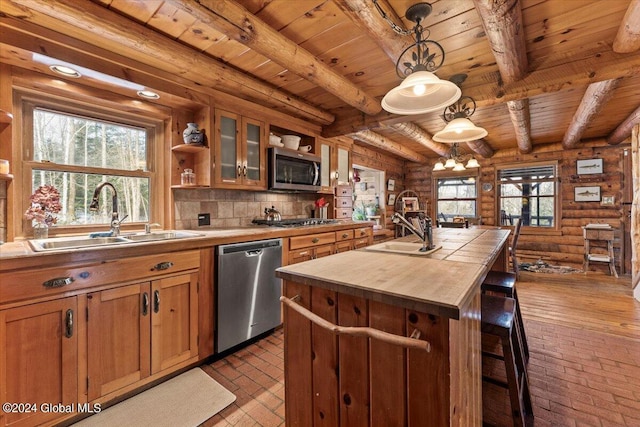 kitchen with open shelves, rustic walls, appliances with stainless steel finishes, wooden ceiling, and a sink