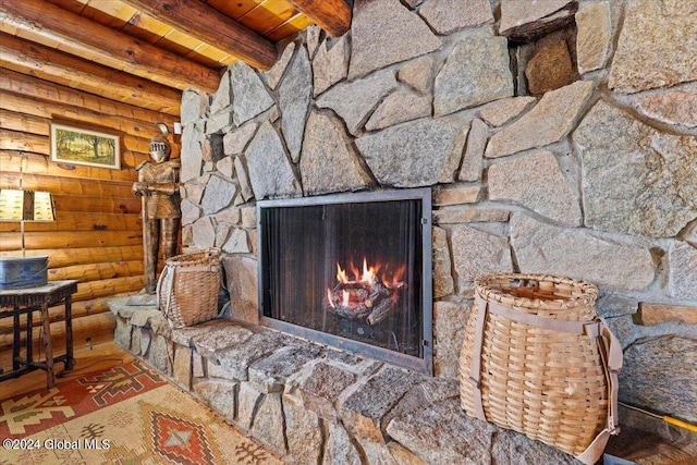 details featuring beamed ceiling, a fireplace, wood finished floors, and wood ceiling