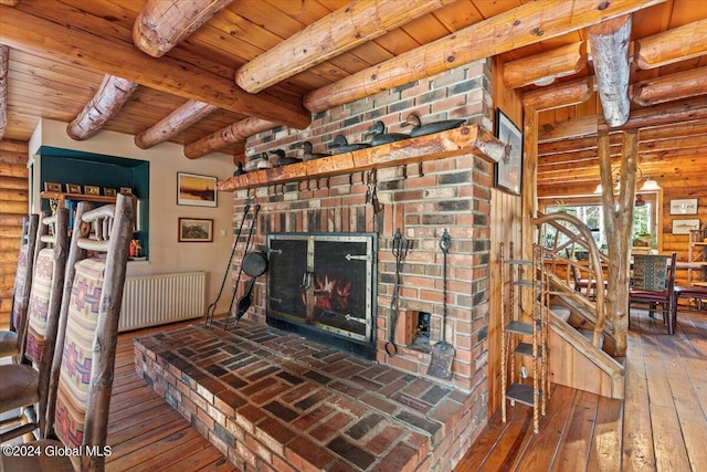 unfurnished living room with log walls, a brick fireplace, radiator, beam ceiling, and wood ceiling