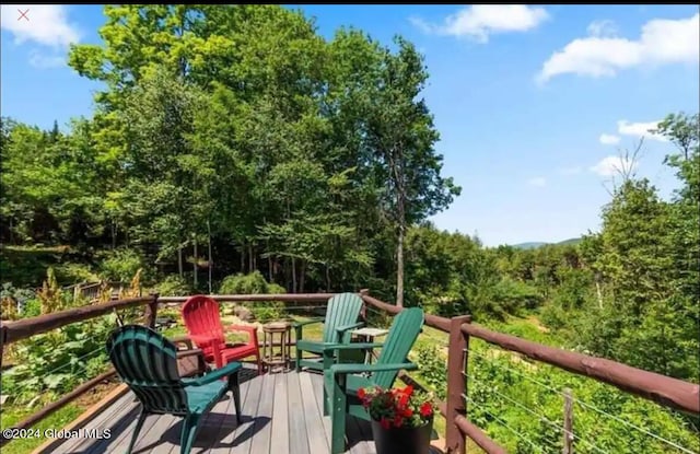 wooden deck with a view of trees