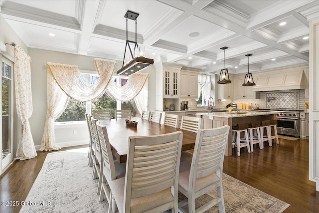 dining area with dark wood-style flooring, beamed ceiling, and coffered ceiling