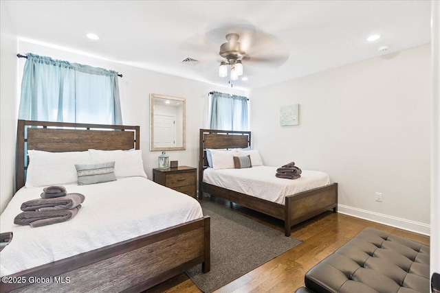 bedroom with a ceiling fan, baseboards, recessed lighting, wood finished floors, and visible vents