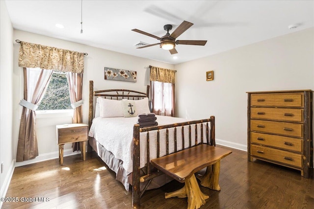 bedroom with baseboards, multiple windows, and dark wood-style floors
