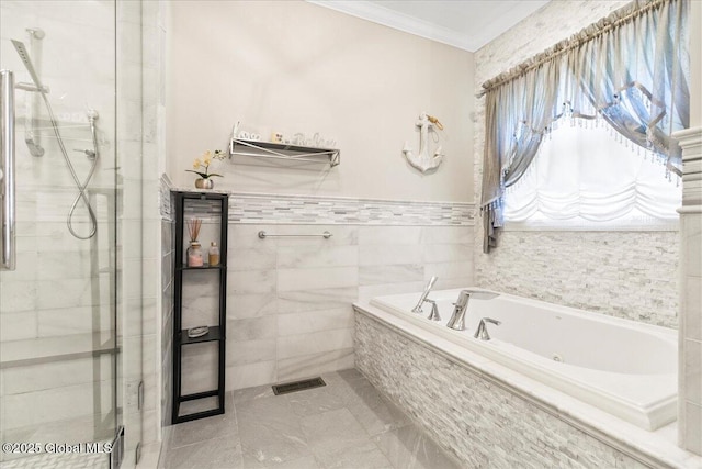 full bathroom with a jetted tub, tile walls, ornamental molding, and a stall shower