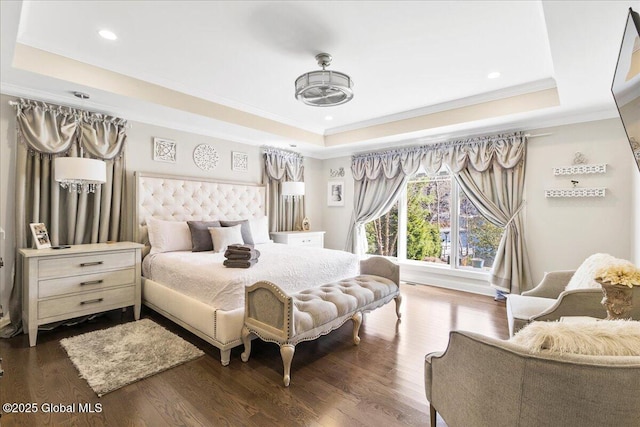 bedroom featuring crown molding, a raised ceiling, recessed lighting, and dark wood-style flooring