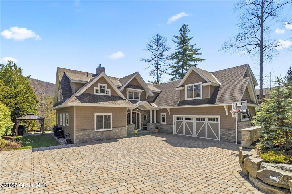135 Seelye Rd, Queensbury, NY 12804 - view of front of house featuring a gazebo, decorative driveway, stone siding, and a chimney