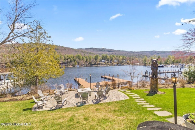property view of water with a dock and a mountain view