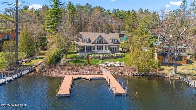exterior space featuring a water view and a yard