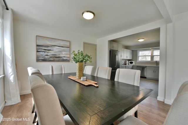 362 Lake Ave, Saratoga Springs, NY 12866 - dining area with baseboards and light wood-type flooring