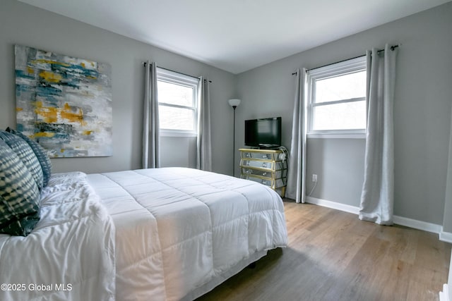 362 Lake Ave, Saratoga Springs, NY 12866 - bedroom featuring baseboards, multiple windows, and wood finished floors