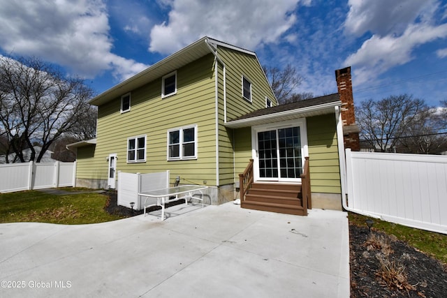362 Lake Ave, Saratoga Springs, NY 12866 - back of property with entry steps, fence, a chimney, and a patio area
