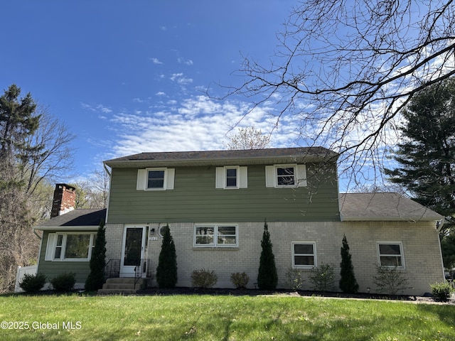 362 Lake Ave, Saratoga Springs, NY 12866 - colonial home with brick siding, a front lawn, and a chimney