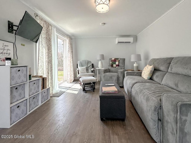 living area featuring a wall unit AC, ornamental molding, and wood finished floors