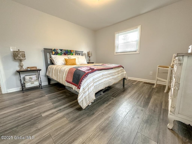 bedroom featuring wood finished floors and baseboards