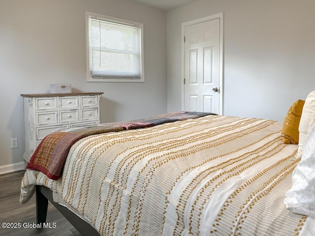 bedroom featuring baseboards and wood finished floors