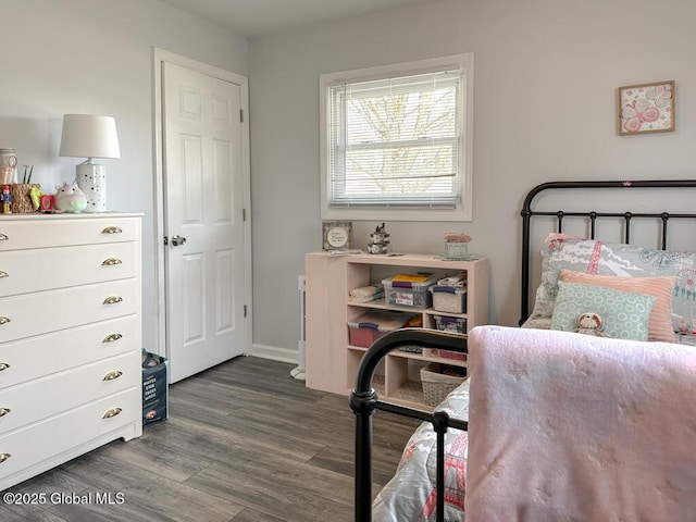 bedroom with baseboards and wood finished floors