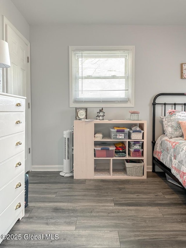 bedroom with baseboards and wood finished floors